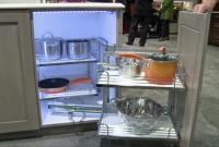 Kitchen cabinet door swinging out to display built-in shelving