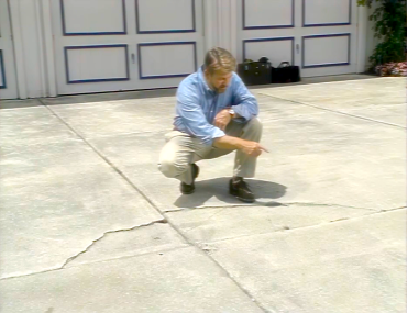 How to Repair a Cracked Concrete Driveway Ron pointing to crack in Driveway 