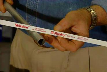 Man holds hacksaw blade