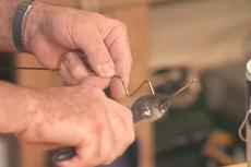 using a coat hanger as paint stirrer