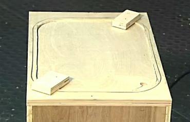 scrap wood blocks holding panel in place