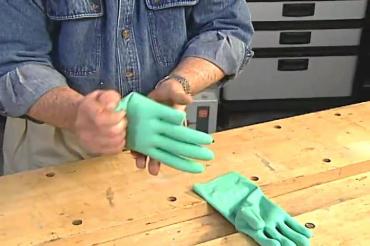 squeezing the cuff of the glove