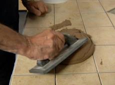 applying grout to the tile
